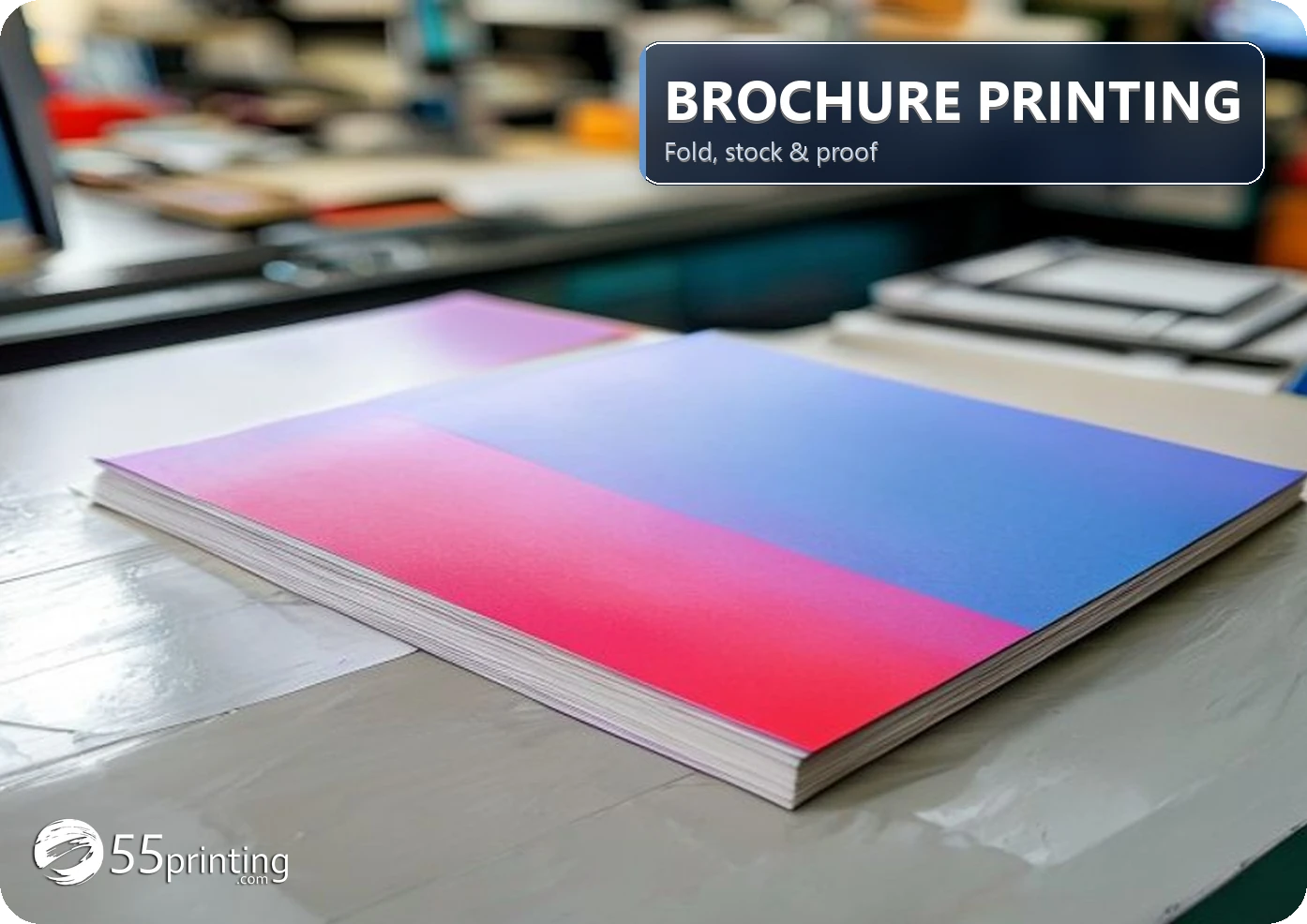 Stack of full-color trifold brochures on a print shop table